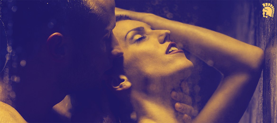 Man and woman having doggy style sex in the shower.